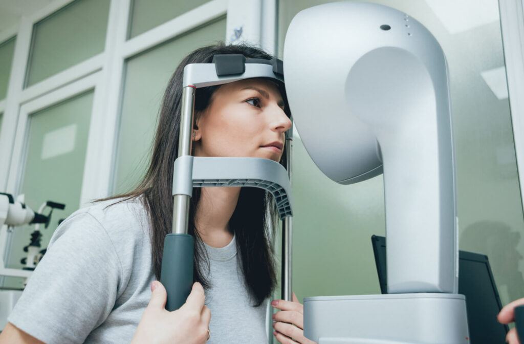 A female patient is undergoing a corneal topography to map the shape of your cornea helpful for ensuring a precise measurement of your corneal curvature