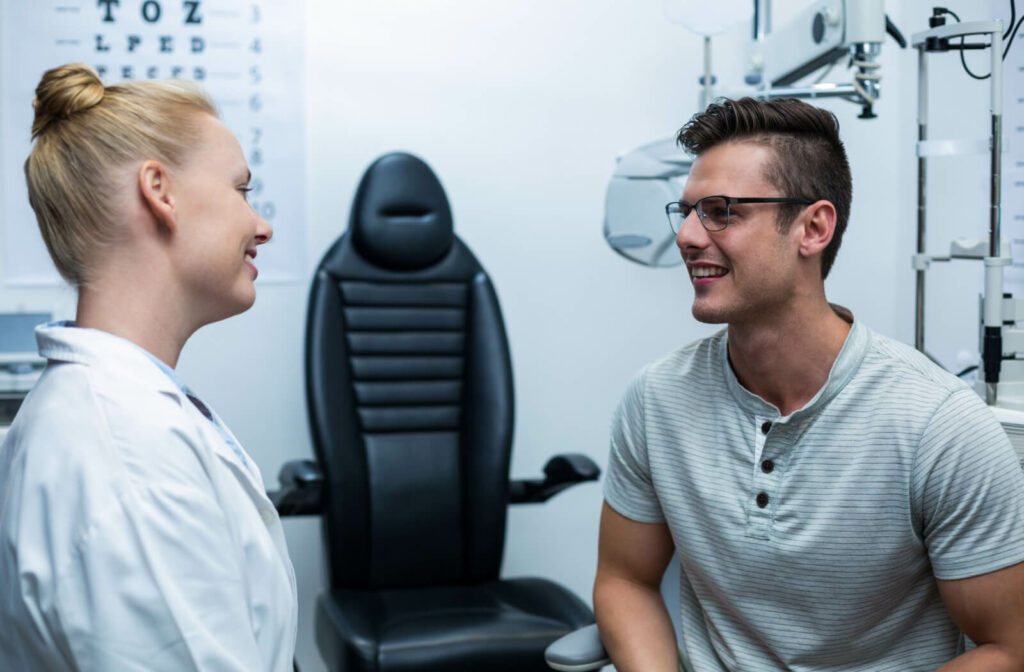 An optometrist talking to her patient in an exam room.