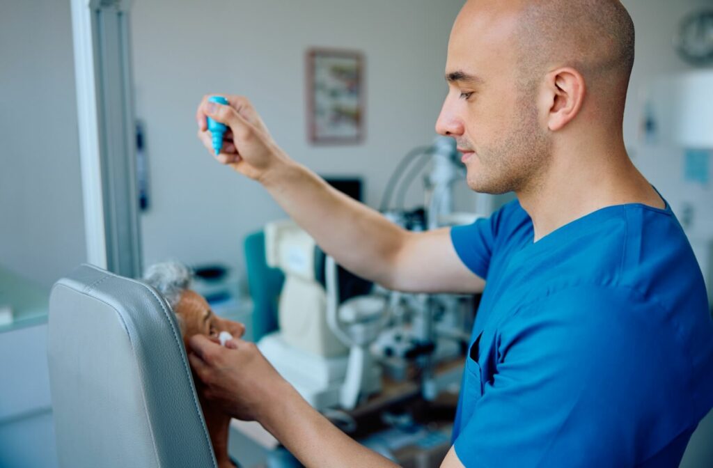 An optometrist carefully administers dilating eye drops to a patient during their annual diabetic eye exam.